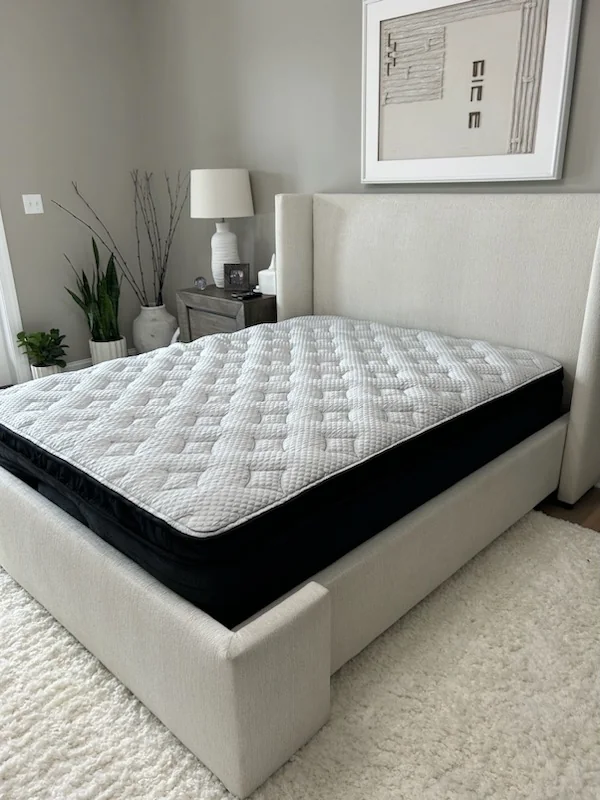 White and black mattress in bedroom setting
